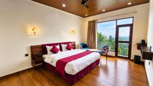 a hotel room with a bed and a large window at Dharamshila Retreat in Chakrāta