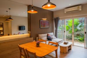 a living room with a table and a couch at The Opium Chiang Mai in Chiang Mai
