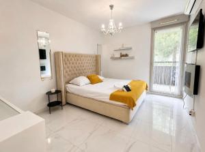 a bedroom with a bed and a television in it at Appartement luxury in Montpellier