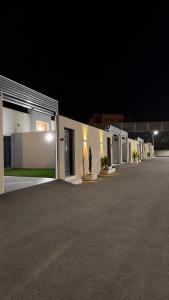 a row of buildings with lights on them at night at وحدات سكنية الشفا in Khamis Mushayt