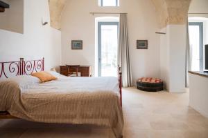 a bedroom with a bed with an orange pillow on it at Masseria Galeasi in Grottaglie +102 photos