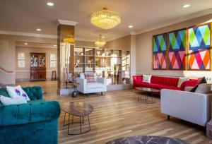 a living room with furniture and a chandelier at JA The Bruntsfield - Edinburgh in Edinburgh