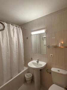 a bathroom with a sink and a toilet and a shower at Hotel La Brañina in Villablino +19 photos