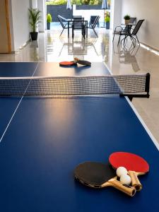 two ping pong paddles on a ping pong table at Our Villa - Villa Rena in Rethymno