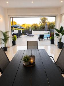 a black dining table with chairs and a patio at Our Villa - Villa Rena in Rethymno +24 photos