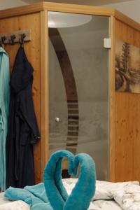 two blue towels on a bed in front of a mirror at Ferienwohnung am Waldweg in Kolsass +59 photos