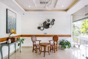 a dining room with a table and chairs at Treebo Misty Garden Resort & Spa With Swimming Pool in Munnar