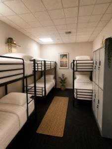 a room with four bunk beds and a rug at Brunsi Hostel in Melbourne