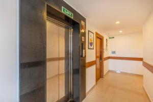 an elevator in a building with a sign on it at Treebo Misty Garden Resort & Spa With Swimming Pool in Munnar