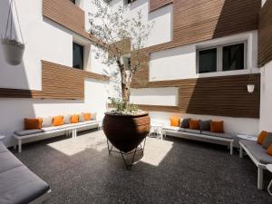 a courtyard with a large pot with a tree in it at The Classic Hotel Nicosia - Handwritten Collection in Nicosia