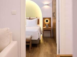 a bedroom with a white bed and a table at The Classic Hotel Nicosia - Handwritten Collection in Nicosia +166 photos