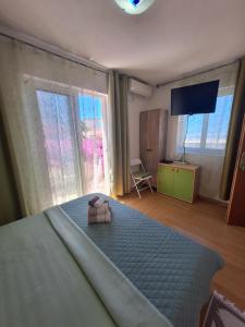 a bedroom with a bed and a large window at Villa Lyudmila in Utjeha +84 photos