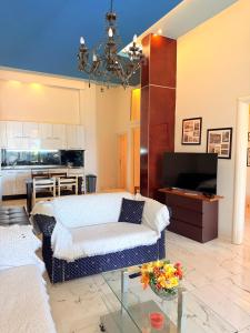 a living room with a bed and a kitchen at Premier Sea Apartment in Paleo Tsifliki