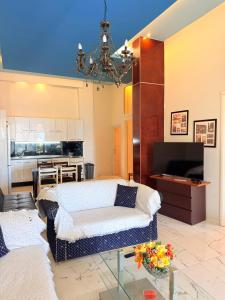 a living room with a couch and a table at Premier Sea Apartment in Paleo Tsifliki