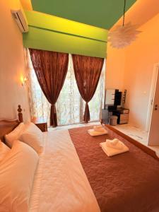 a bedroom with a large bed with two towels on it at Premier Sea Apartment in Paleo Tsifliki