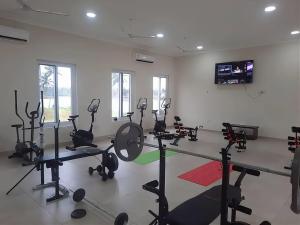a gym with several treadmills and exercise bikes at Nyansapo Eco Resort in Cape Coast