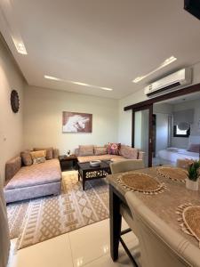 a living room with a couch and a table at Segal 2 Hawana Salalah Forest Island in Salalah +37 photos
