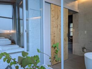 a bathroom with a shower and a glass door at 都蘭小星民宿 Dulan Star Guest House in Donghe +30 photos
