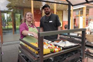 a man and a woman standing next to a table of food at DJH Jugendherberge Xanten in Xanten