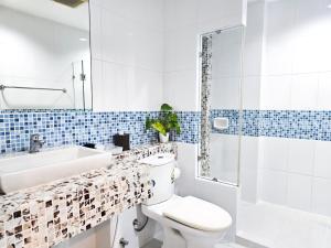 a bathroom with a toilet and a sink and a tub at The Beach Bangsaen Condo 327/30 in Ban Bang Saen (1) +6 photos