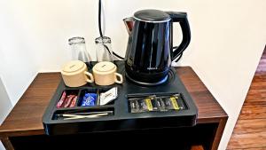 a black blender sitting on top of a table at Dharamshila Retreat in Chakrāta