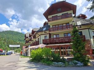 a large building with balconies on the side of it at Apartments 17 - 23 AD Kamzík in Donovaly