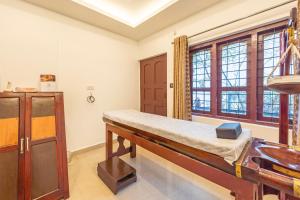 a hospital room with a bed and a window at Treebo Misty Garden Resort & Spa With Swimming Pool in Munnar