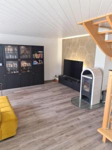 a living room with a wood floor and a fireplace at Ferienwohnung Grahn 15154 in Leer