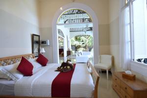 a bedroom with a large bed and an archway at Villa Mimosa in Lovina +50 photos
