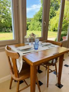 a dining room table with two chairs and a window at GITES EN BAIE DE SOMME - Maison Nolette in Noyelles-sur-Mer +17 photos