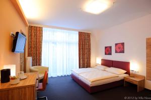מיטה או מיטות בחדר ב-Villa Nova - Hotel garni