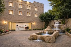 a stone building with a fountain in front of a building at Sultan Otel Mardin in Sultan Koyu +37 photos