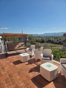 a patio with chairs and tables and a gazebo at Volo Libero - Guest House in Poggio Bustone +20 photos