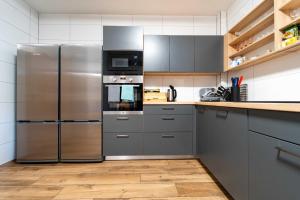 a kitchen with a stainless steel refrigerator and microwave at Chata Markétka in Dobré