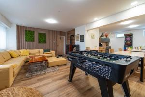 a living room with a large ping pong table at Chata Markétka in Dobré