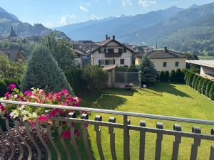 a view of a house from a balcony with flowers at Apartments Trettel in Tesero