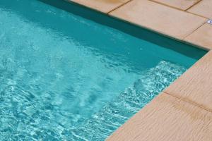 a pool of blue water with a tile floor at Quinta do Nobre in Marialva