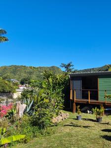 a view of a tiny house in a garden at Chalet Tikaz Sandjo in Entre-Deux