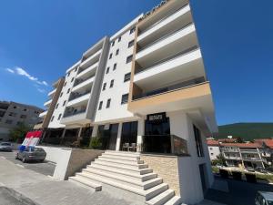 a white building with stairs in front of it at Apartment Niko in Posušje