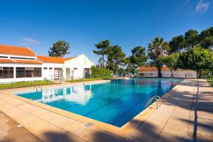 a large swimming pool in front of a building at Kampaoh Sesimbra in Sesimbra