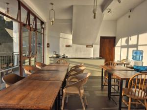 a group of tables and chairs in a restaurant at Ella, Nine Glow Resort in Ella +45 photos