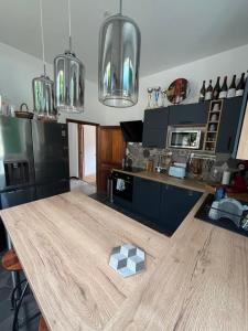 a kitchen with a wooden table and some lights at Village vacations in Guarguale +10 photos