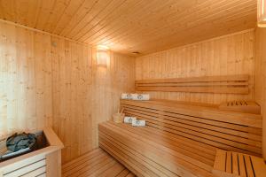 a sauna with wooden walls and a wooden floor at ROGOChalet in Rogojel