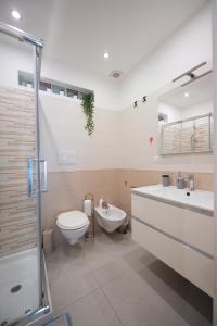 a bathroom with a toilet and a sink and a shower at La VILLA in Modugno +31 photos