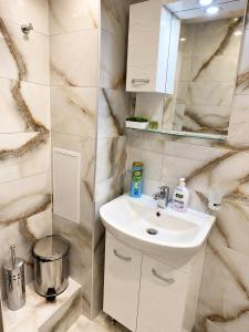a bathroom with a sink and a mirror at Apartment Be Happy 3, Premium Apartment in Ruse City Centre in Ruse +32 photos