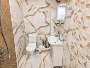 a bathroom with a toilet and a sink and a mirror at Apartment Be Happy 3, Premium Apartment in Ruse City Centre in Ruse