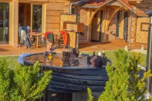 three children playing in a pool in a backyard at Chalets Waldeck - Urlaub im Fränkischen Seenland und Altmühltal in Raitenbuch