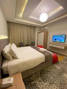 a hotel room with a large bed and a television at Golden New Tulip in Abha