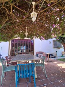 a table and chairs sitting under an umbrella at villa amodeo in Paceco