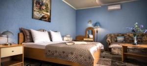 a bedroom with a bed and a chair in a room at Old Town in Izmail +63 photos
